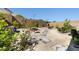 Serene backyard with gravel, flagstone pavers, and a stone bird bath at 11652 Desert Hollow Ave, Las Vegas, NV 89138