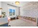 Stylized bedroom with desk, chair, floral wallpaper and built in storage at 11652 Desert Hollow Ave, Las Vegas, NV 89138