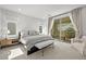 Bright bedroom with a cozy bed, bench, patio access with mountain views and seating at 11652 Desert Hollow Ave, Las Vegas, NV 89138