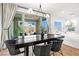 Sun-filled dining room with sliding glass doors to a landscaped backyard patio and garden at 11652 Desert Hollow Ave, Las Vegas, NV 89138