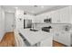 Bright kitchen with white cabinets, stainless steel appliances and a center island with quartz countertops at 11652 Desert Hollow Ave, Las Vegas, NV 89138