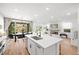 Open concept: kitchen island view of living room with fireplace feature at 11652 Desert Hollow Ave, Las Vegas, NV 89138