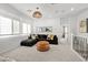 Comfortable living area features plush sectional, ottoman, and natural light from large window at 11652 Desert Hollow Ave, Las Vegas, NV 89138