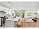 Open floor plan showcasing kitchen with island and living room with fireplace at 11652 Desert Hollow Ave, Las Vegas, NV 89138