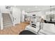 Open concept first floor, featuring a modern staircase, a living space and a kitchen in the background at 11652 Desert Hollow Ave, Las Vegas, NV 89138