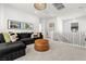 Cozy loft area with a comfortable sofa, plush ottoman and an abundance of natural light at 11652 Desert Hollow Ave, Las Vegas, NV 89138