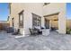 Relaxing outdoor space with pavers, comfortable seating, and a cozy fire pit at 11652 Desert Hollow Ave, Las Vegas, NV 89138