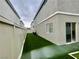 A small backyard with artificial turf, bordered by a white fence for added privacy at 11953 Haven St, Las Vegas, NV 89183