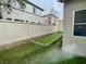 A cozy backyard with artificial turf, enclosed by a white fence at 11953 Haven St, Las Vegas, NV 89183