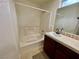 Bathroom features a bathtub with shower and a single sink with dark wood cabinets at 11953 Haven St, Las Vegas, NV 89183