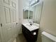 Bathroom with a single sink vanity, toilet, and a door at 11953 Haven St, Las Vegas, NV 89183