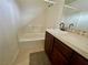 Bathroom features a bathtub with shower and a single sink with dark wood cabinets at 11953 Haven St, Las Vegas, NV 89183