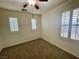 Bedroom with neutral carpet, plantation shutters, and a ceiling fan at 11953 Haven St, Las Vegas, NV 89183