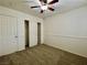 Bedroom with a ceiling fan, neutral carpet and paint, and a closet with sliding doors at 11953 Haven St, Las Vegas, NV 89183