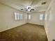 Spacious bedroom features neutral carpet, ceiling fan and multiple windows with plantation shutters at 11953 Haven St, Las Vegas, NV 89183