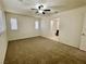 Spacious bedroom features neutral carpet, ceiling fan and windows with plantation shutters at 11953 Haven St, Las Vegas, NV 89183