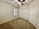 Bedroom with neutral carpet, ceiling fan, plantation shutters, and closet at 11953 Haven St, Las Vegas, NV 89183