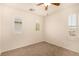 Bedroom with neutral carpet, ceiling fan, and multiple windows, offering plenty of natural light at 11953 Haven St, Las Vegas, NV 89183