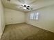 Bedroom features neutral carpet, ceiling fan and a window with plantation shutters at 11953 Haven St, Las Vegas, NV 89183