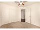 Bedroom with carpet, ceiling fan, closet and a view of the laundry room at 11953 Haven St, Las Vegas, NV 89183