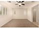 Bedroom featuring neutral colored walls and carpets and plantation shutters on the windows at 11953 Haven St, Las Vegas, NV 89183