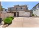 Front of a two-story stucco home featuring a two-car garage, desert landscaping, and muted trim at 11953 Haven St, Las Vegas, NV 89183