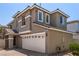 Side view of a two-story stucco home with a two-car garage and trimmed windows at 11953 Haven St, Las Vegas, NV 89183