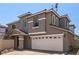 Two-story home with a white two-car garage, neutral stucco and nicely kept landscaping at 11953 Haven St, Las Vegas, NV 89183