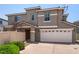Two-story home with a neutral stucco exterior, white trim, a covered porch, and a two-car garage at 11953 Haven St, Las Vegas, NV 89183