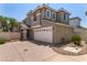 Two-story home showing neutral stucco, white trim, two-car garage and driveway at 11953 Haven St, Las Vegas, NV 89183