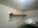 Garage featuring concrete flooring, painted walls, and overhead shelving for storage at 11953 Haven St, Las Vegas, NV 89183