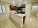 Cozy kitchen features stainless appliances, tile flooring and countertops, plus dark cabinets at 11953 Haven St, Las Vegas, NV 89183