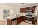 Kitchen with dark cabinets, stainless appliances, tile countertops and a stainless steel sink at 11953 Haven St, Las Vegas, NV 89183