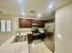 Eat-in kitchen features stainless appliances, tile countertops, and dark cabinetry at 11953 Haven St, Las Vegas, NV 89183