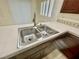 Close up of kitchen sink featuring tile countertops and updated faucet at 11953 Haven St, Las Vegas, NV 89183