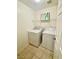 Laundry room with tile flooring, washer, dryer, and shelving for storage at 11953 Haven St, Las Vegas, NV 89183