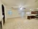 Bright living area features tile flooring, shutters, and seamlessly connects to kitchen at 11953 Haven St, Las Vegas, NV 89183