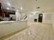 Open-concept living room with tile floors, fireplace, and kitchen with modern appliances at 11953 Haven St, Las Vegas, NV 89183