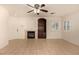 Open living space featuring neutral tile, a ceiling fan, and a fireplace with built-in storage at 11953 Haven St, Las Vegas, NV 89183