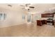 Open layout featuring neutral tile, bright lighting, and a kitchen area with dark cabinets at 11953 Haven St, Las Vegas, NV 89183