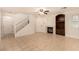 Bright living room features neutral tile flooring, a fireplace, built-in shelving, and staircase at 11953 Haven St, Las Vegas, NV 89183