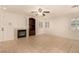 Spacious living room features a fireplace, built-in shelves, neutral paint and tile floors at 11953 Haven St, Las Vegas, NV 89183
