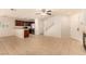 Open layout with neutral tile flooring connecting living room and kitchen with stainless appliances at 11953 Haven St, Las Vegas, NV 89183