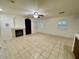 Inviting living space with fireplace, built-in shelving, tile flooring, and bright shutters at 11953 Haven St, Las Vegas, NV 89183
