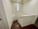 Staircase with dark wood flooring, white walls, and a bright window with white shutters at 11953 Haven St, Las Vegas, NV 89183