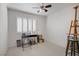 Bright bedroom featuring plantation shutters, ceiling fan, and neutral walls at 1219 Heather Oaks Way, North Las Vegas, NV 89031
