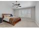 Spacious bedroom with plantation shutters, ceiling fan, and a cozy bed at 1219 Heather Oaks Way, North Las Vegas, NV 89031