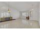 Bright living room featuring tile floors, plantation shutters, and natural light at 1219 Heather Oaks Way, North Las Vegas, NV 89031