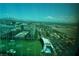 Aerial view of the Topgolf, city, and surrounding mountains at 145 E Harmon Ave # 27621, Las Vegas, NV 89109