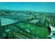 Aerial view of the Topgolf, city, and surrounding mountains at 145 E Harmon Ave # 27621, Las Vegas, NV 89109
